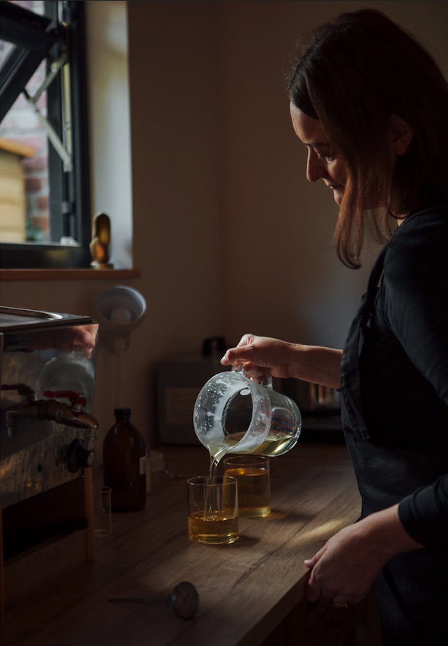 Lesley Bramwell - Essence and Alchemy - Lesley filling candles - Aucoot Estate Agents